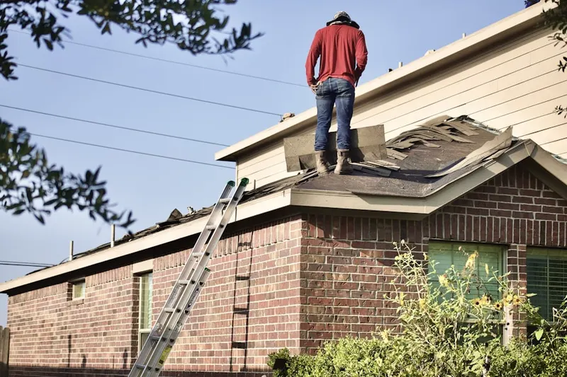 Professional roofer working on a residential roof in Braggville Station